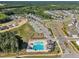 Vibrant aerial view displays a community with a pool and playground at 743 Hadstock Path Path, Zebulon, NC 27597