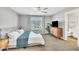 Bedroom with a queen bed, ceiling fan, large windows, and stylish furnishings at 743 Hadstock Path Path, Zebulon, NC 27597