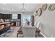 Elegant dining area with a wooden table, upholstered chairs, and modern decor creating a warm and inviting atmosphere at 743 Hadstock Path Path, Zebulon, NC 27597