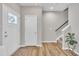 Inviting entryway with neutral walls, wood floors, a staircase and a decorative plant that add a touch of nature at 743 Hadstock Path Path, Zebulon, NC 27597