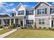 Charming townhome featuring a stone and siding facade, well-kept landscaping, and a welcoming front porch at 743 Hadstock Path Path, Zebulon, NC 27597
