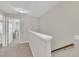 Upstairs hallway featuring neutral walls, carpet flooring, and staircase at 743 Hadstock Path Path, Zebulon, NC 27597