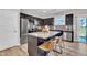 Modern kitchen features stainless steel appliances, dark wood cabinets and a large granite island with seating at 743 Hadstock Path Path, Zebulon, NC 27597