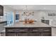 Large granite kitchen island provides ample counter space and transitions into open-concept living at 743 Hadstock Path Path, Zebulon, NC 27597