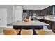 Modern kitchen boasts a large granite island with seating and stainless steel appliances at 743 Hadstock Path Path, Zebulon, NC 27597