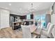 Bright open kitchen and dining area with stainless steel appliances and a modern chandelier at 743 Hadstock Path Path, Zebulon, NC 27597