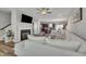 Open-concept living room with a fireplace, large sectional sofa, and seamless flow into the kitchen and dining area at 743 Hadstock Path Path, Zebulon, NC 27597