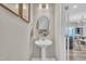 Stylish powder room features a pedestal sink, oval mirror and decorative accents at 743 Hadstock Path Path, Zebulon, NC 27597