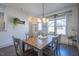 Bright dining room featuring a wood table, stylish chairs, and large window with greenery at 777 Fireball Ct, Knightdale, NC 27545