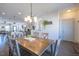 Open-concept dining area with a wood table and stylish lighting, perfect for gatherings at 777 Fireball Ct, Knightdale, NC 27545