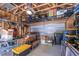 A spacious garage with overhead storage racks and ample space for vehicles and storage containers at 777 Fireball Ct, Knightdale, NC 27545