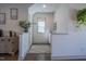 Hallway featuring hardwood floors, natural light, and decorative plants, adding a touch of nature at 777 Fireball Ct, Knightdale, NC 27545