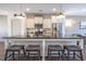 Modern kitchen featuring white cabinets, stainless steel appliances, and a dark countertop island at 777 Fireball Ct, Knightdale, NC 27545