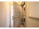 Conveniently located laundry room includes a stacked washer and dryer unit and shelving at 777 Fireball Ct, Knightdale, NC 27545