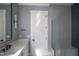 Modern bathroom with marble countertop vanity, gray walls, glass shower, and a sleek, minimalist design at 7805 Ailesbury Rd, Wake Forest, NC 27587