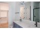 Modern bathroom boasts double sinks, quartz countertop, and a tiled glass shower at 7805 Ailesbury Rd, Wake Forest, NC 27587