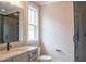 Modern bathroom with a gray vanity, glass shower, and updated fixtures for a sleek design at 7805 Ailesbury Rd, Wake Forest, NC 27587