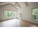 Bright bedroom with vaulted ceiling, wood floors, and multiple windows providing natural light at 7805 Ailesbury Rd, Wake Forest, NC 27587