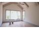 A bright bedroom with a vaulted ceiling, large windows, and freshly painted at 7805 Ailesbury Rd, Wake Forest, NC 27587