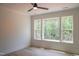 Well-lit bedroom features hardwood floors, a ceiling fan, and a large window at 7805 Ailesbury Rd, Wake Forest, NC 27587