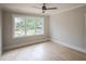 Bright bedroom with a large window showcasing the wooded exterior at 7805 Ailesbury Rd, Wake Forest, NC 27587