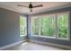 Well-lit bedroom with hardwood floors and scenic views from large windows overlooking the backyard at 7805 Ailesbury Rd, Wake Forest, NC 27587