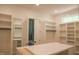A spacious walk-in closet with custom shelving and ample storage space and shower at 7805 Ailesbury Rd, Wake Forest, NC 27587