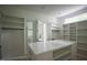 Spacious walk-in closet with center island, custom shelving, and hanging racks for ample storage at 7805 Ailesbury Rd, Wake Forest, NC 27587