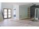 Open-concept living room with fireplace and staircase, offering a spacious and inviting atmosphere at 7805 Ailesbury Rd, Wake Forest, NC 27587