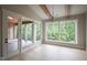 Bright living room with large windows providing a view of the forest at 7805 Ailesbury Rd, Wake Forest, NC 27587