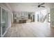 Open-concept living room and kitchen with an island, stairs, and a large sliding glass door at 7805 Ailesbury Rd, Wake Forest, NC 27587