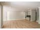 Open-concept living room with hardwood floors, a wet bar, and access to the stairway at 7805 Ailesbury Rd, Wake Forest, NC 27587