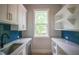 Well-organized pantry with built-in shelves, bright window, and a stylish tiled backsplash at 7805 Ailesbury Rd, Wake Forest, NC 27587