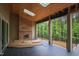 Outdoor patio with a fireplace, skylights, and forest view at 7805 Ailesbury Rd, Wake Forest, NC 27587