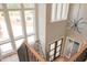 Elegant staircase with modern railings and views of natural light from large windows at 7805 Ailesbury Rd, Wake Forest, NC 27587
