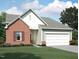 Charming brick and siding home with a two-car garage and well-maintained lawn at 805 Kenyon Spring Dr, Zebulon, NC 27597