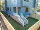 Backyard with a privacy fence, grass, and stairs to the house at 805 Tower St # 102, Raleigh, NC 27607