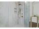 Luxurious glass shower with modern fixtures and stone-look tiles in a Primary bathroom at 805 Tower St # 102, Raleigh, NC 27607