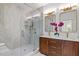 Luxurious bathroom with a glass-enclosed shower, double vanity with wood cabinets, and modern fixtures at 805 Tower St # 102, Raleigh, NC 27607