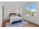 Cozy bedroom with natural light, hardwood floors, and a view of the neighborhood at 805 Tower St # 102, Raleigh, NC 27607