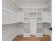 Spacious walk-in closet featuring custom shelving and wooden hanging rods for ample storage at 805 Tower St # 102, Raleigh, NC 27607