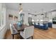 Dining area featuring hardwood floors, modern lighting, and views into a well-appointed kitchen at 805 Tower St # 102, Raleigh, NC 27607