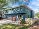 Modern two-story home featuring a three-car garage, blue siding, and a well-manicured lawn at 805 Tower St # 102, Raleigh, NC 27607