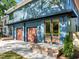 Close up of the home's exterior, highlighting the garage doors, entryway, and blue siding at 805 Tower St # 102, Raleigh, NC 27607