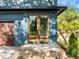 Modern blue home featuring a stylish wood-frame glass front door and a brick-lined entryway at 805 Tower St # 102, Raleigh, NC 27607