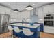 Elegant kitchen with two-tone cabinetry, quartz countertops, stainless steel appliances, and pendant lighting at 805 Tower St # 102, Raleigh, NC 27607