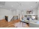 Bright living room with a white ceiling fan, modern furniture, and staircase with iron spindles at 805 Tower St # 102, Raleigh, NC 27607