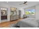 Spacious main bedroom showcasing wood floors, a ceiling fan, and an ensuite bathroom at 805 Tower St # 102, Raleigh, NC 27607