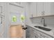 Mudroom features cabinets, sink and view to living room through doorway at 805 Tower St # 102, Raleigh, NC 27607