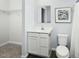 Bathroom with a white vanity, toilet, and a linen closet for storage at 806 Bright Nova Way, Wendell, NC 27591